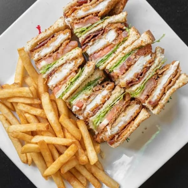 BLT's Breakfast Lunch & Takeout's chicken club sandwich with bacon, lettuce, tomato, and fries.